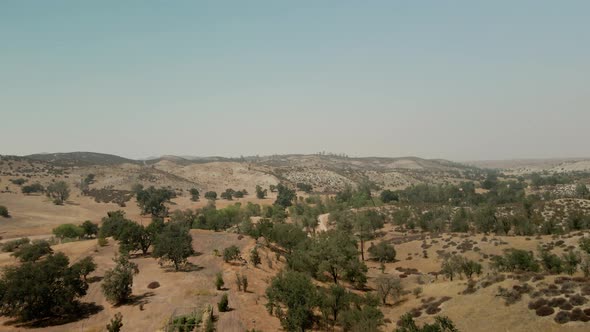 Drone flying forward over hot desert in Santa Margarita, California. Aerial view of dry landscape, U