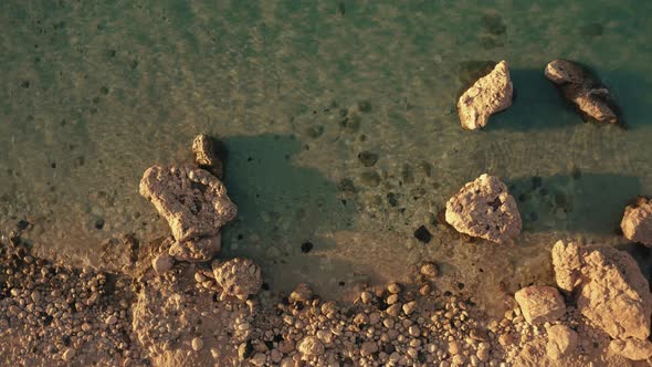 View of Rocky Beach with Transparent Clear Sea Water Close Up