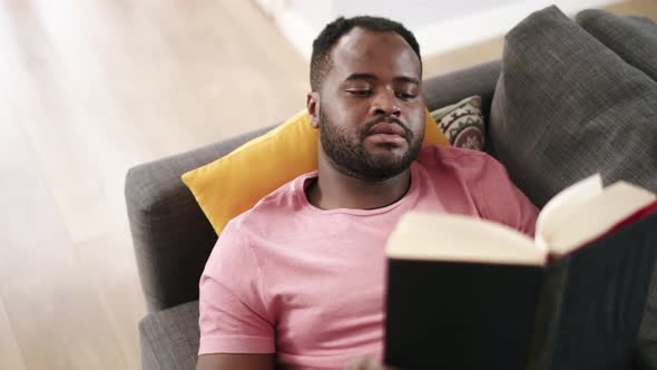 African man reading book