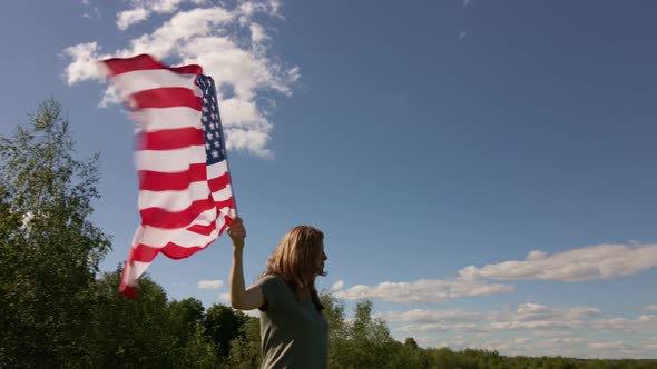 Woman Holds Waving American Flag