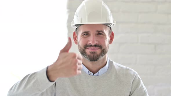 Portrait of Positive Young Engineer Doing Thumbs Up 