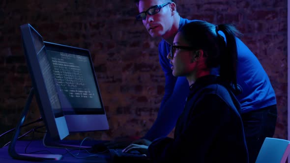 Woman and man working together at computers