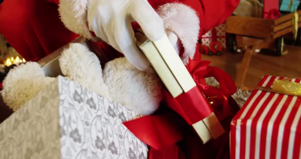 Santa claus removing gift boxes from sack