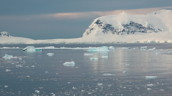 Colorful Mountains at Sunset in Antarctica. Mirror reflection in Ocean Water. Beauty world, holidays