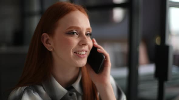 Closeup Face of Cheerful Young Woman Holding Mobile Phone Happily Calling and Chatting at Home