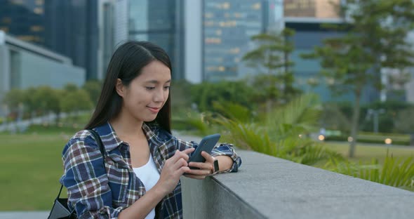 Woman look at mobile phone in city