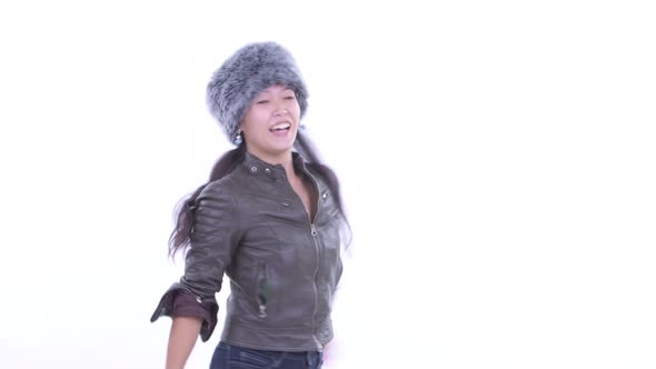 Happy Beautiful Asian Woman Dancing and Ready for Winter