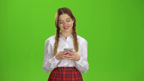 Student Writes a Message on the Smartphone. Green Screen