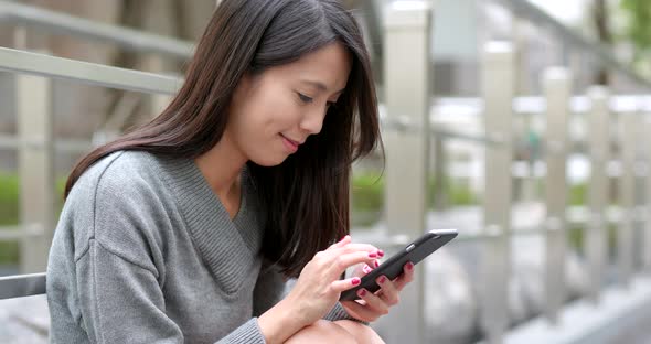 Woman use of cellphone at outdoor