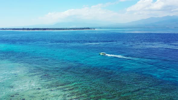 Island In Hawaii - Boat Smoothly Sailing Over The Bright Blue Sea Water With Coral Reef At The Botto