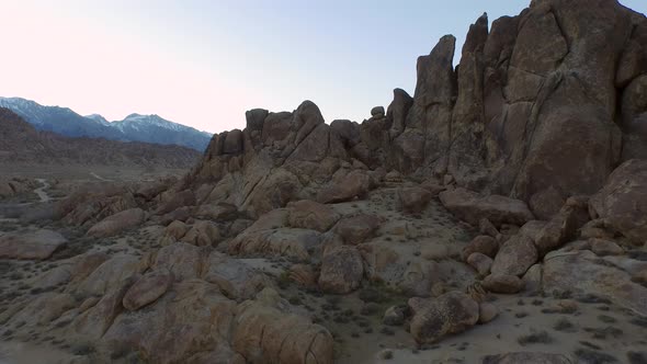 Aerial shot of a young man backpacker camping with his dog in a mountainous desert