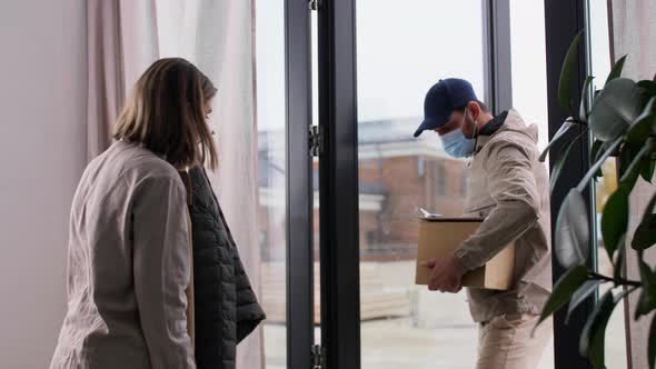 Delivery Man in Mask with Box and Customer at Home