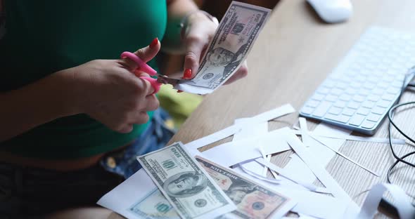 Woman Cuts Out One Hundred Dollar American Banknotes From Paper