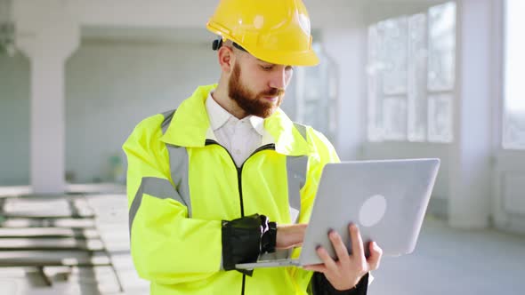 Charismatic Engineer Man at Construction Site in a