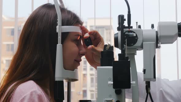 Young Woman Checking He  Pupil Reaction To Light