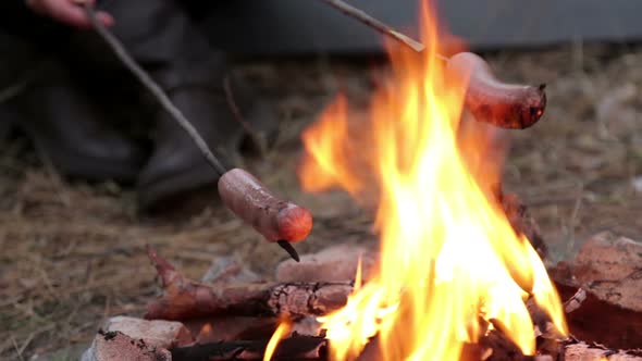 Girl is Preparing Sausages on Campfire