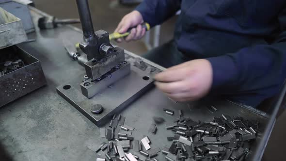 The Worker Creates a Metal Product at the Factory Using a Special Machine