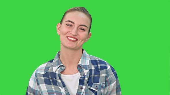 Cheerful Young Woman Talking To a Camera on a Green Screen, Chroma Key