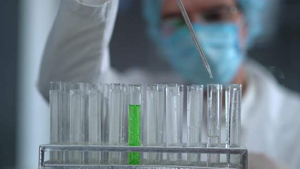 Drop With A Pipette Green Liquid Into A Test Tube
