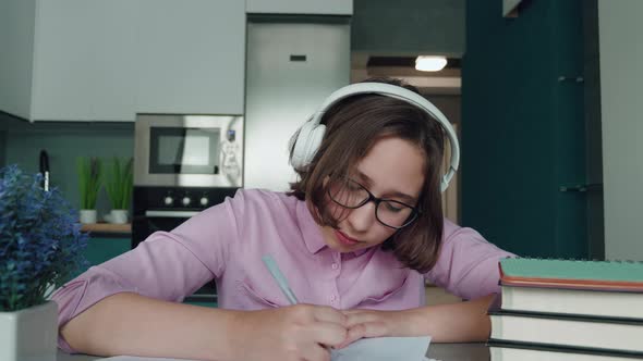 Happy Schoolgirl Pupil Wearing Headphones Raising Hand Distance Learning Online at Virtual Lesson