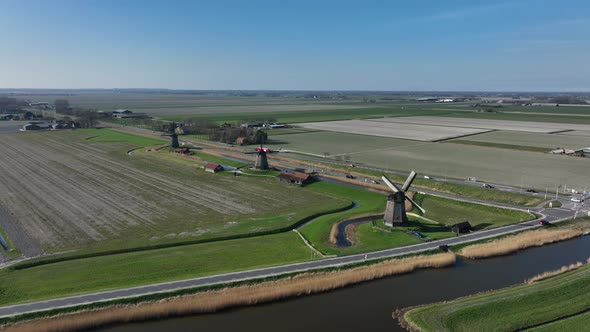 Historic Dutch Windmills in a Farm and Grass Field Landscape in The Netherlands Holland