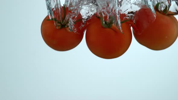 Tomatoes splashing into water in slow motion; shot on Phantom Flex 4K at 1000 fps