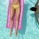 Woman Lying on Inflatable and Man Swimming Underwater in Pool - VideoHive Item for Sale
