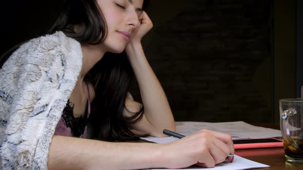 Long Haired Student with Pen Naps Holding Head on Hand