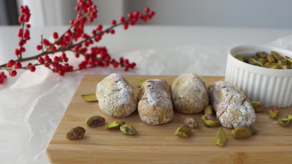 Closeup slider shot of a setup for food photography, chewy pistachio amaretti Christmas cookies