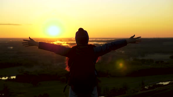 Young Free Girl Tourist Travels in Nature Alone. Woman Traveler with Backpack Comes To the Edge