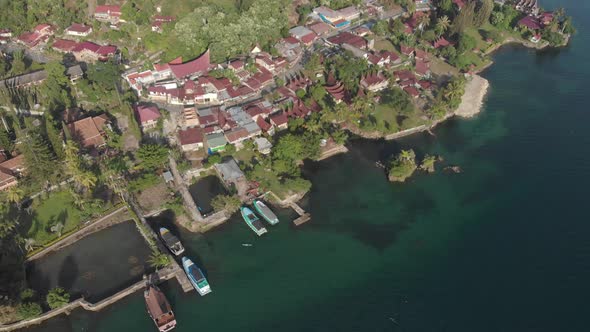 Aerial: flying over lake Toba and Samosir Island Sumatra Indonesia. Tuk Tuk traditional village and