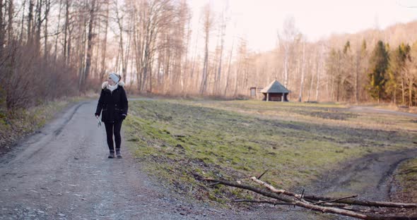 Smiling Female Tourist Walking Trail in Mountains