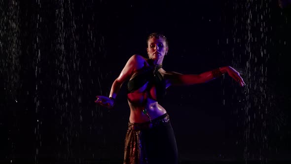 Belly Dance Under Rain Woman is Dancing Slowly in Darkness Traditional Oriental Dance Performance