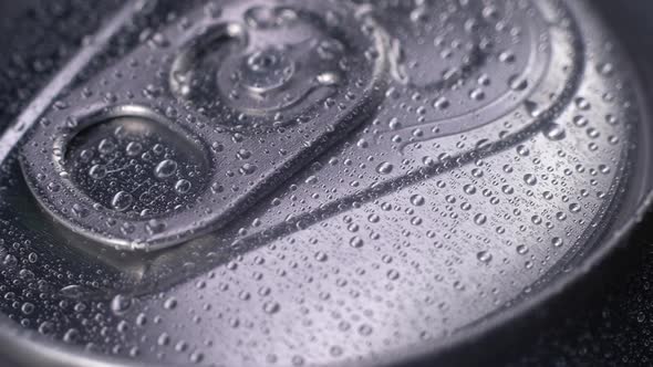 macro shooting of a wet aluminum can with drops of clear water