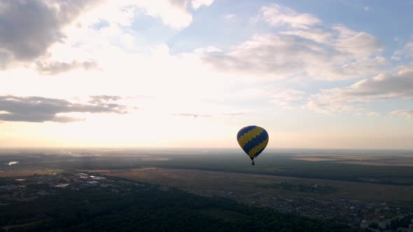 Aerial Drone View of Colorful Air Balloon Flying Over Green Park in Small European City at Summer