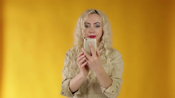 Excited Carefree European Girl Blogger Takes Photos of Girlfriend Using Smartphone, Holds Camera