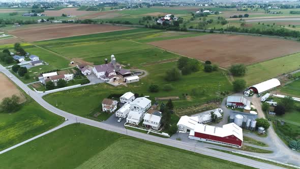 Aerial View of Amish Farm Lands Fields, Barns, and Homes in Spring
