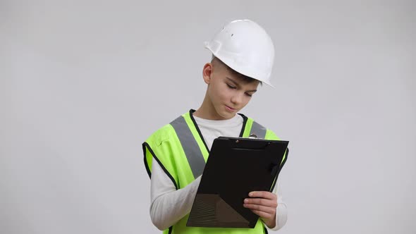 Little Cheerful Boy Having Fun Writing with Banana Imitating Filling in Industrial Document