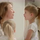 Mom in Pajamas Communicates with Her Daughter and Kisses Her - VideoHive Item for Sale
