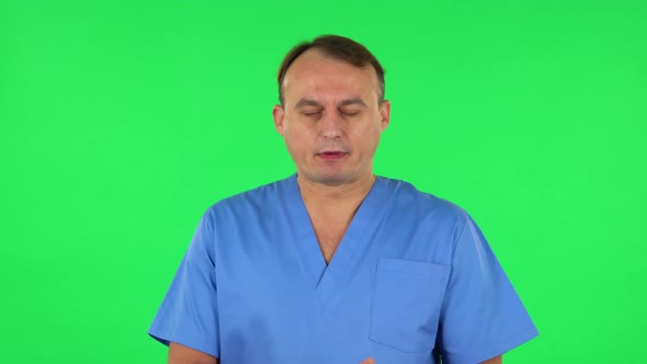 Medical Man Claps His Hands Indifferently. Green Screen