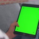 woman holding in hands a digital tablet with green screen for internet online - VideoHive Item for Sale