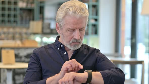Old Man Using Smartwatch