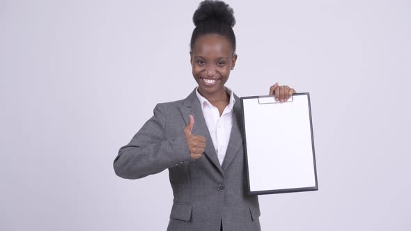 Young Happy African Businesswoman Showing Clipboard and Giving Thumbs Up