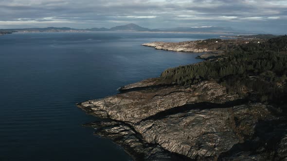 Flying above rocky coast in vestern Norways fjord