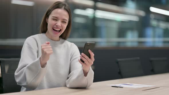 Successful Woman Celebrating on Smartphone