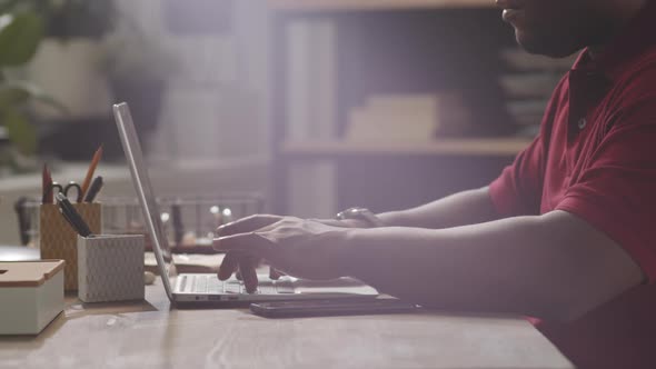 Close Up of Black Man Using Laptop in Office