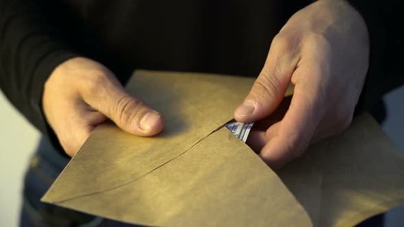 Man Hands Putting Pile of Amican Dollar Money Into the Envelope Bribe