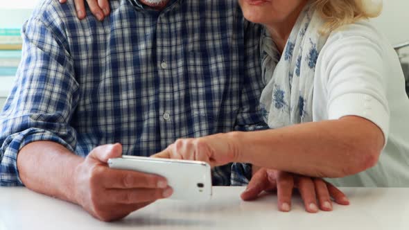 Senior couple using mobilephone