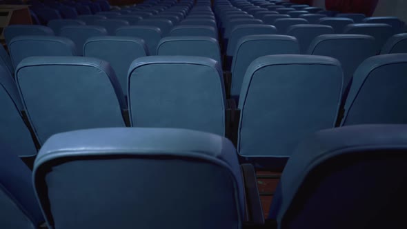 Empty cinema. Film premiere without spectators. Movie spotlight. Blue chairs