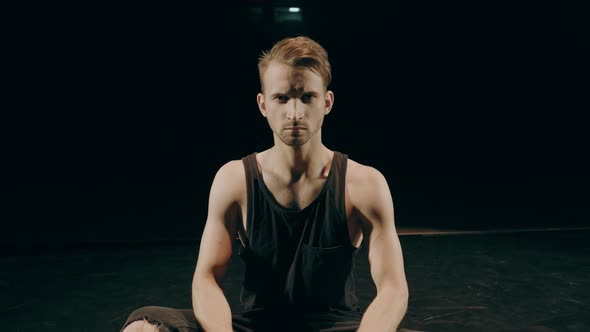 Terrible, Angry Close-up Portrait of a Man on Dark Background.  Raw Log Ungraded Footage